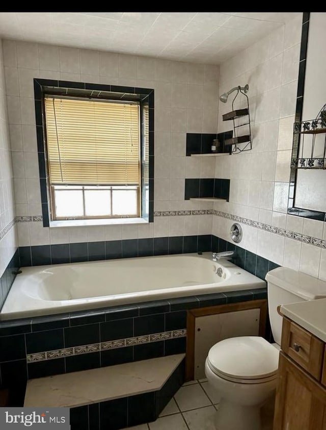 full bathroom with tile patterned flooring, toilet, tile walls, and vanity