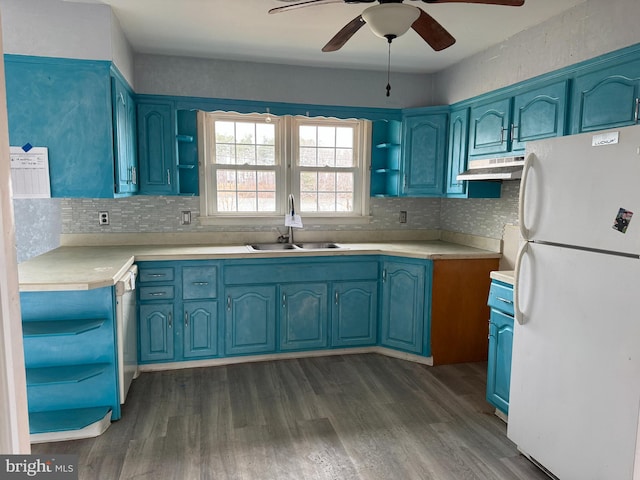 kitchen with a sink, blue cabinetry, and freestanding refrigerator