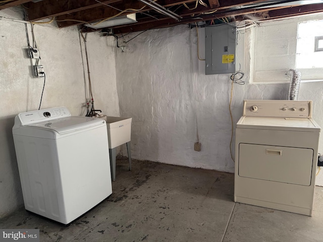 laundry room featuring electric panel, laundry area, and washing machine and dryer