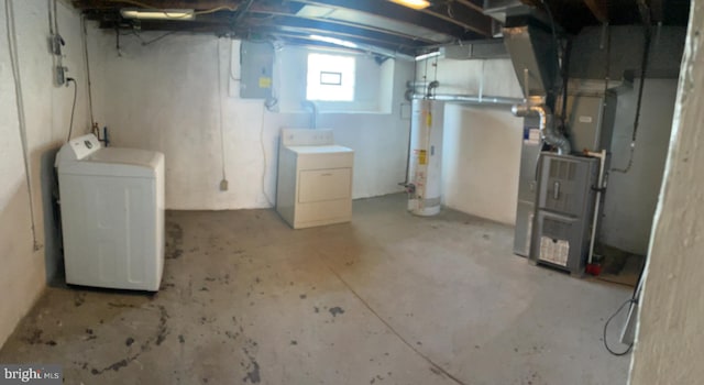 below grade area with independent washer and dryer, electric panel, and water heater