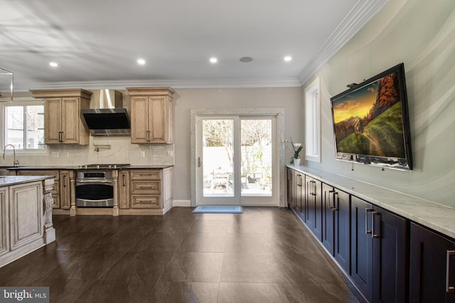 kitchen with decorative backsplash, stove, wall chimney range hood, and plenty of natural light