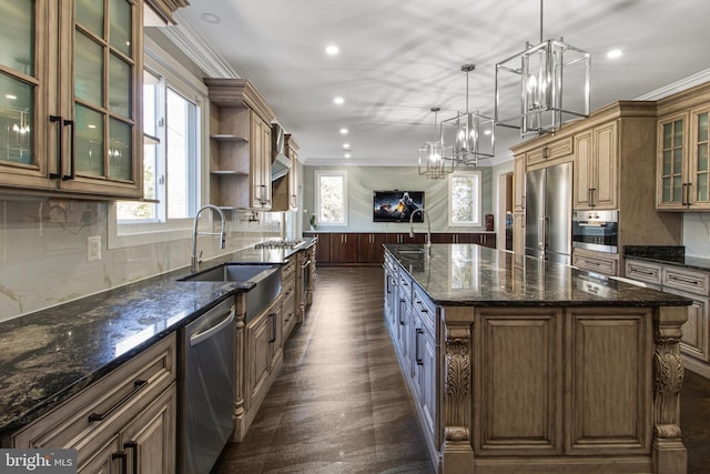 kitchen featuring a wealth of natural light, a wainscoted wall, stainless steel appliances, and a sink