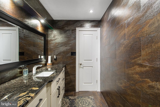 bathroom featuring tile walls and vanity