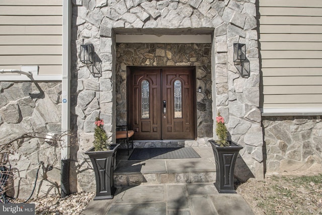 property entrance with stone siding