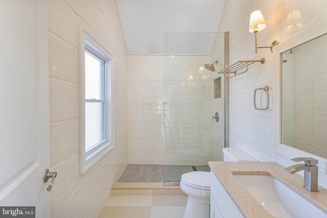 bathroom with tiled shower, toilet, and vanity