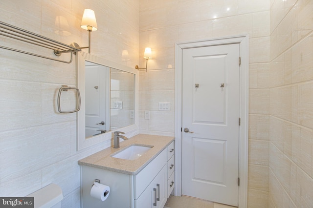 bathroom featuring tile walls and vanity