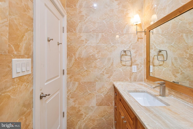 bathroom featuring tile walls and vanity