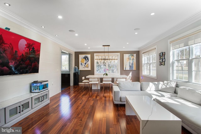 living room featuring recessed lighting, an inviting chandelier, dark wood-style floors, and crown molding