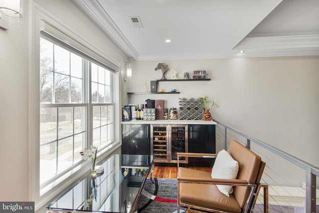 bar featuring visible vents, crown molding, a dry bar, recessed lighting, and light wood-style flooring