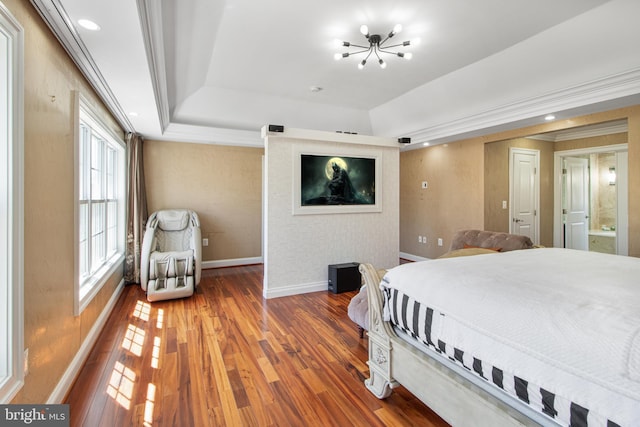 bedroom with a chandelier, crown molding, baseboards, and wood finished floors