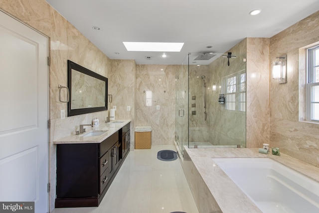 bathroom with a sink, tile walls, a bath, and a shower stall