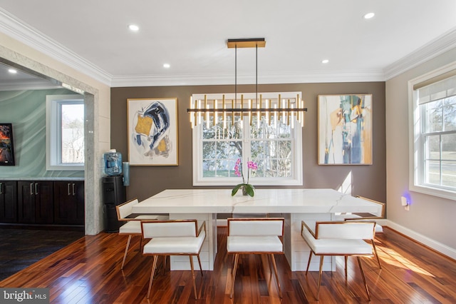 dining area featuring dark wood-style floors, a healthy amount of sunlight, baseboards, and ornamental molding