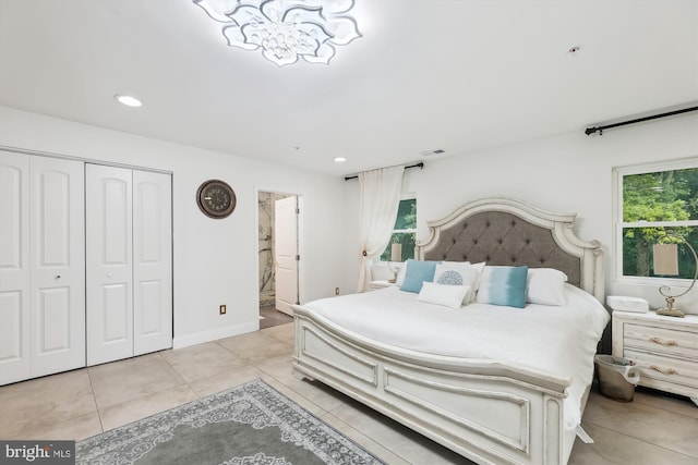 bedroom featuring a closet, multiple windows, visible vents, and light tile patterned floors