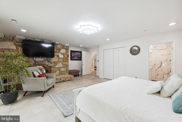 bedroom featuring visible vents, ensuite bath, recessed lighting, a closet, and light tile patterned floors