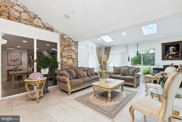 living area featuring vaulted ceiling with skylight and recessed lighting