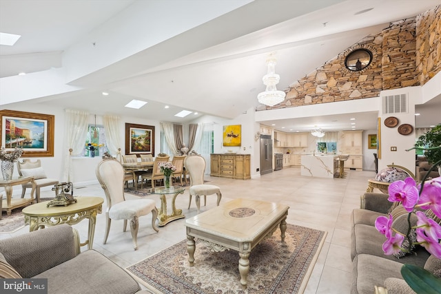 living area with a skylight, light tile patterned floors, visible vents, and high vaulted ceiling