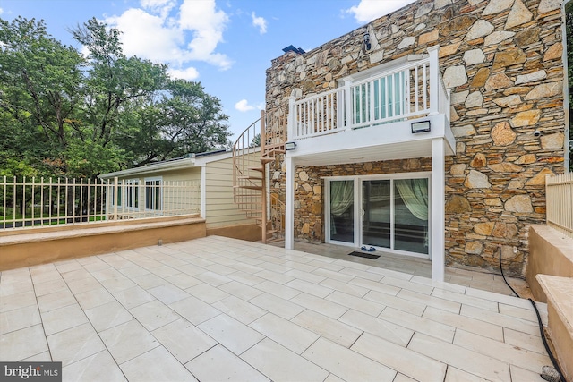 view of patio / terrace featuring a balcony and fence