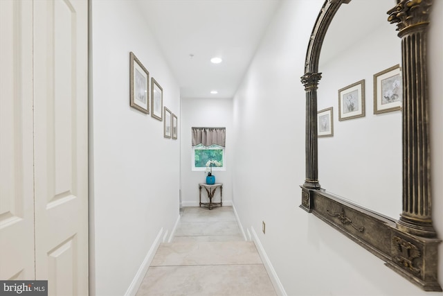 corridor with recessed lighting and baseboards