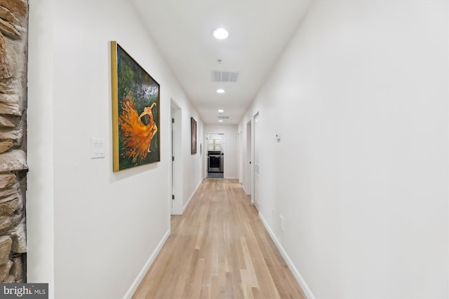 corridor featuring visible vents, recessed lighting, light wood-style flooring, and baseboards