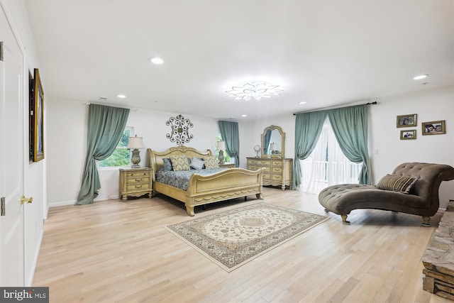 bedroom featuring recessed lighting, baseboards, wood finished floors, and access to outside