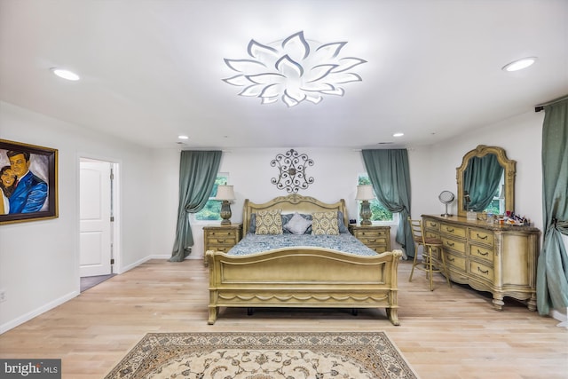 bedroom featuring light wood finished floors, recessed lighting, and baseboards