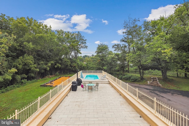 view of pool featuring a fenced in pool, a lawn, a patio, and fence