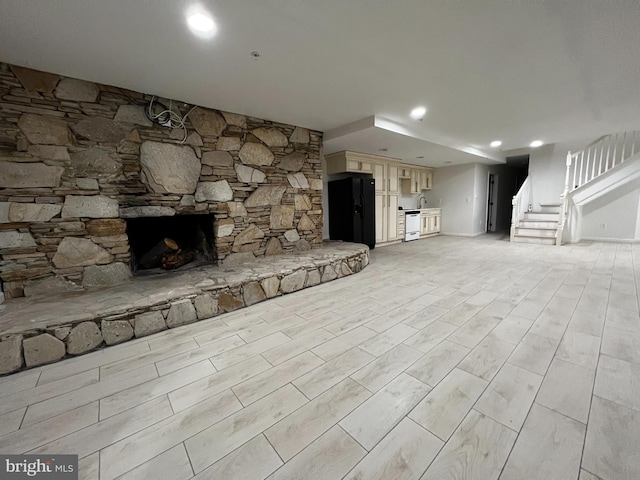 unfurnished living room featuring stairs, recessed lighting, and a fireplace