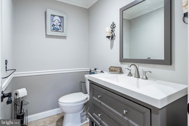 half bath with crown molding, toilet, vanity, and baseboards