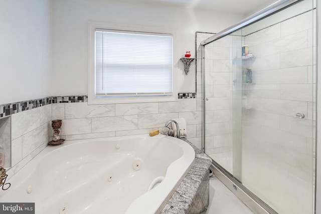 full bathroom with a shower stall and a whirlpool tub