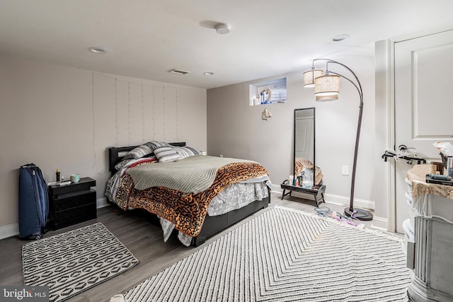 bedroom featuring recessed lighting, wood finished floors, and baseboards