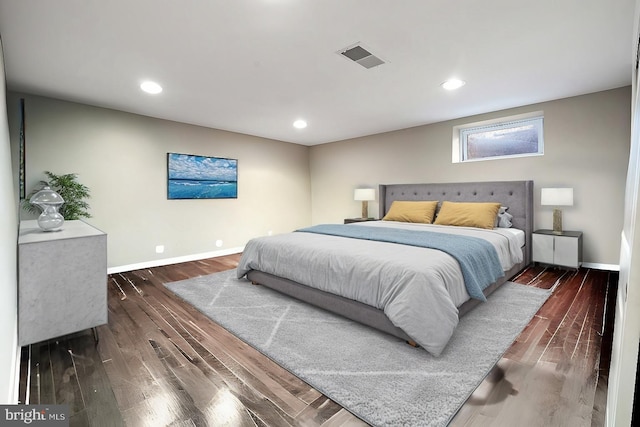 bedroom featuring dark wood finished floors, visible vents, recessed lighting, and baseboards