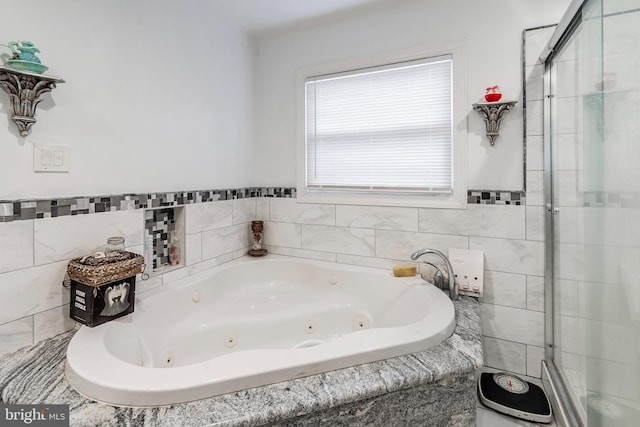 full bath with a shower stall and a whirlpool tub