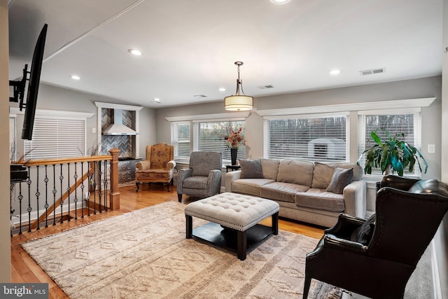 living room featuring visible vents, recessed lighting, and light wood-type flooring