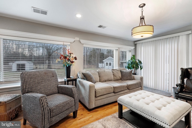 living area featuring light wood-style flooring, recessed lighting, and visible vents