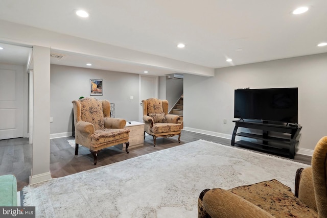 living area featuring visible vents, baseboards, stairs, recessed lighting, and wood finished floors