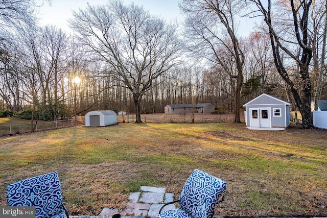 view of yard with an outbuilding, a storage shed, and a fenced backyard