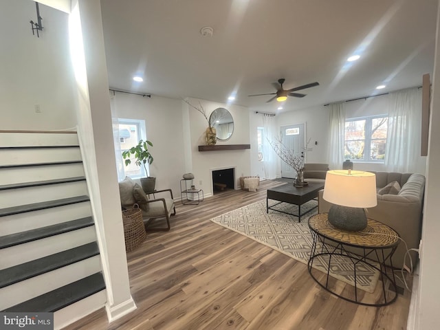 living room with recessed lighting, stairway, wood finished floors, and a ceiling fan