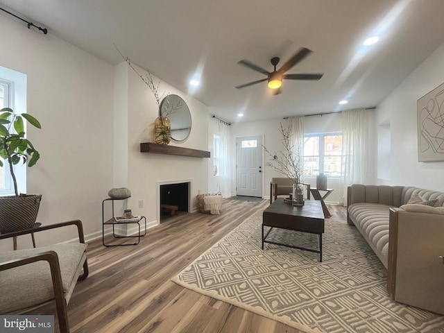 living room with recessed lighting, baseboards, a ceiling fan, and wood finished floors