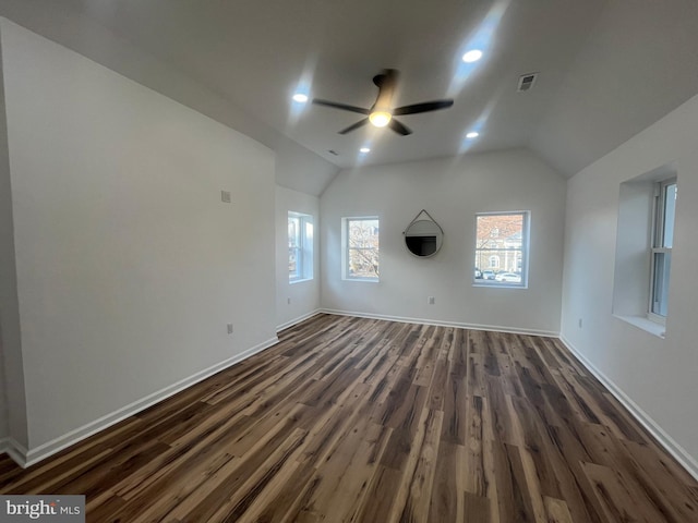 interior space with dark wood-style floors, baseboards, lofted ceiling, and ceiling fan