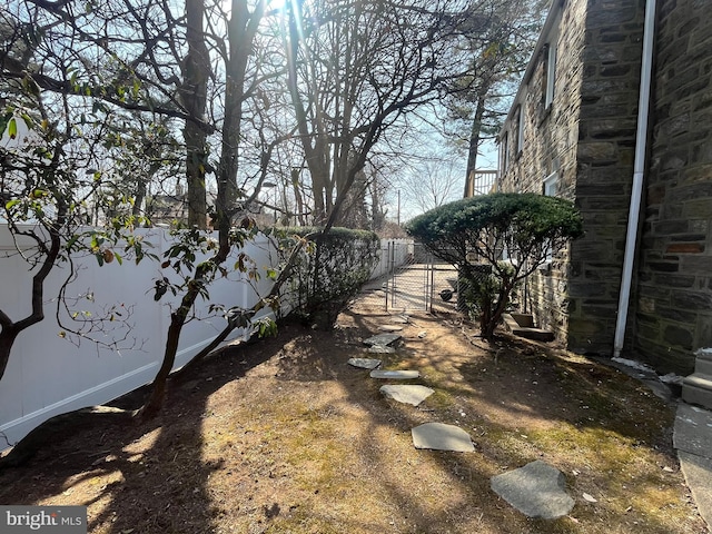 view of yard featuring a gate and fence