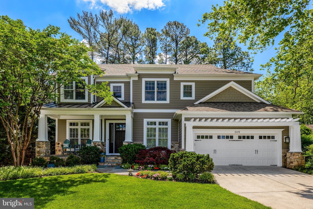 309 Charles St SE, Vienna, VA 22180 - view of front of property featuring stone siding, an attached garage, concrete driveway, and a front lawn