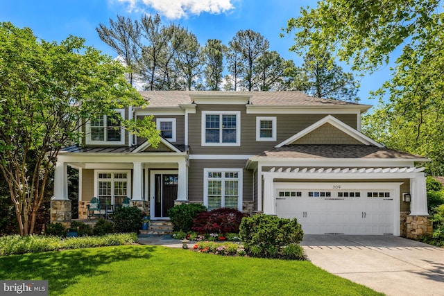 309 Charles St SE, Vienna, VA 22180 - view of front of property featuring stone siding, an attached garage, concrete driveway, and a front lawn