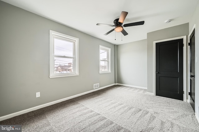 unfurnished bedroom with visible vents, ceiling fan, baseboards, and carpet