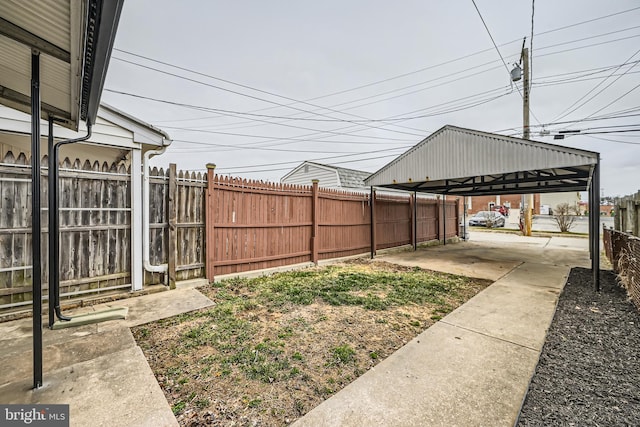 view of yard featuring a carport and fence