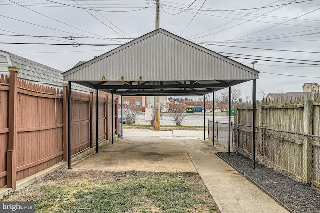 view of vehicle parking with a carport and fence