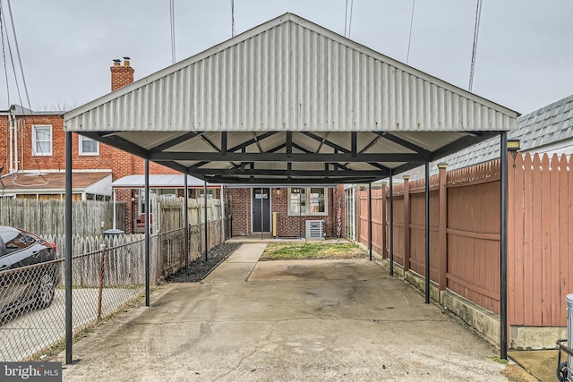 view of car parking with a carport and fence