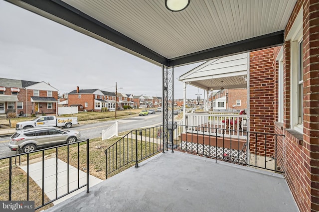 balcony featuring a residential view and a porch