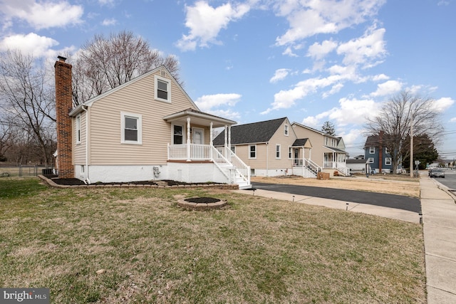 view of front of home featuring a front lawn and a chimney