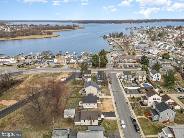 drone / aerial view with a residential view and a water view