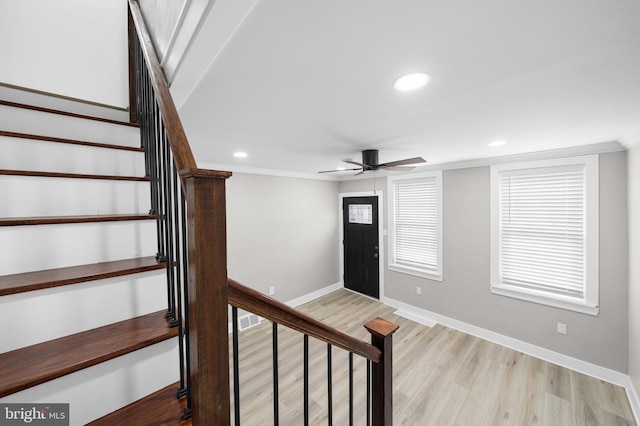 stairway with wood finished floors, recessed lighting, crown molding, baseboards, and ceiling fan